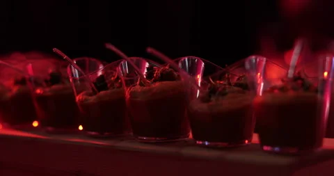 Desserts in cups. A row of glasses with dessert in the middle at a party. Stock Footage 246543170
