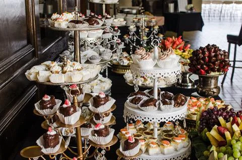 Desserts on display at a display table Stock Photos