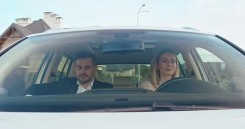 Destination. Beautiful couple sitting on the front passenger seats and smiling Stock Footage 157358323
