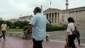Destitute invalid on invalid chair and people on the street in Athens, Greece HD Footage