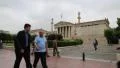 Destitute invalid on invalid chair and people on the street in Athens, Greece HD Footage