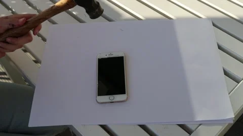 Destroy cellphone with hammer Stock Footage 256106647