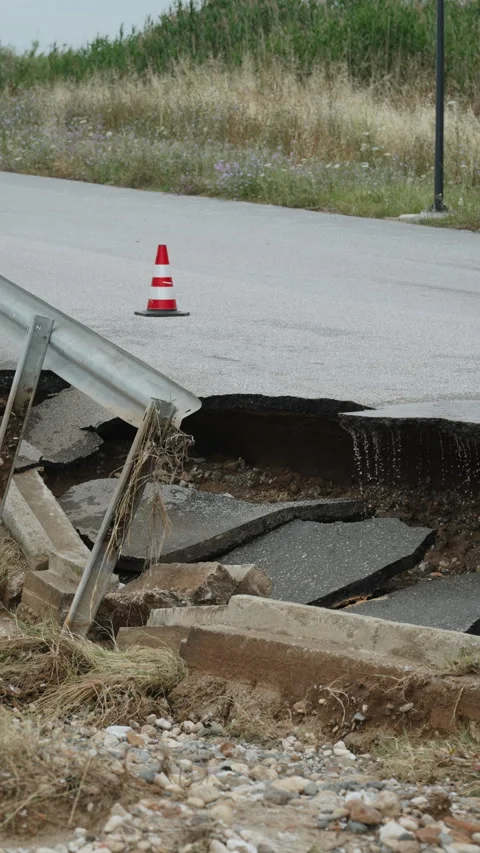 Destroyed asphalt road after destructive rain, vertical video. Stock Footage 303619380