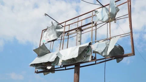 Destroyed, billboard during the Russian aggression in Ukraine. Tattered Stockbeeldmateriaal 221256360