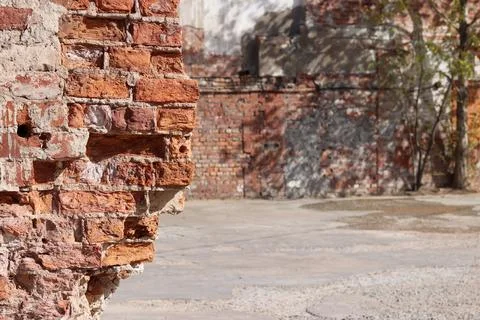 Destroyed brick wall blurred background close up Stock Photos