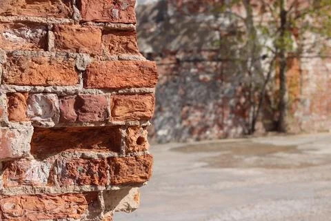 Destroyed brick wall blurred background close up Stock Photos
