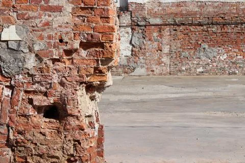 Destroyed brick wall blurred background close up Stock Photos