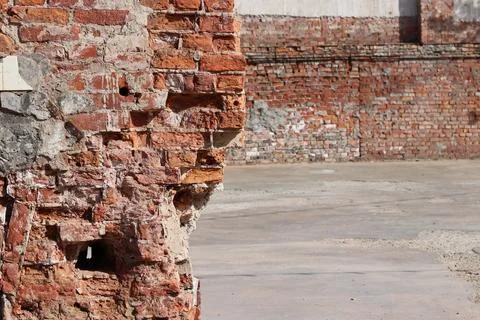 Destroyed brick wall blurred background close up Stock Photos