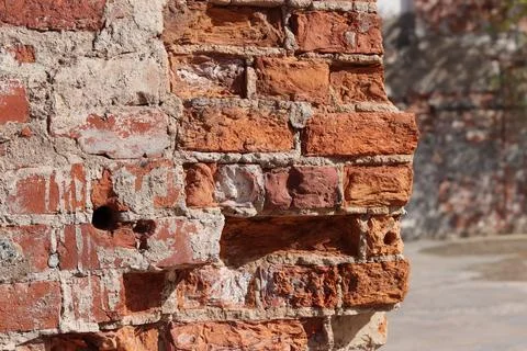 Destroyed brick wall blurred background close up Stock Photos