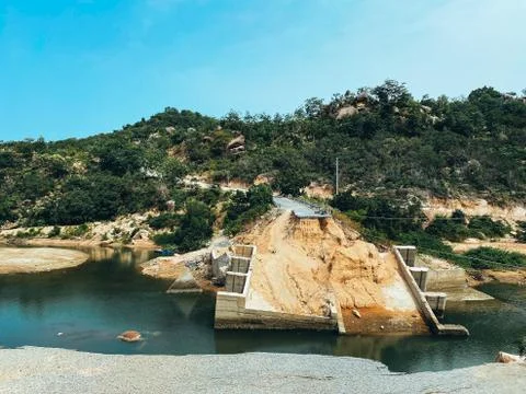 The destroyed bridge over the mountain river. Concrete bridge collapsed after Stock Photos