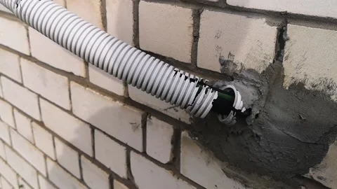 Destroyed, broken protection of electrical cable entry into the house. Stock Footage 219962049