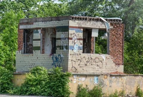 The destroyed building among the trees. Stock Photos