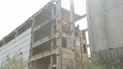 Destroyed building next to which trees grow Stock Footage 125475415