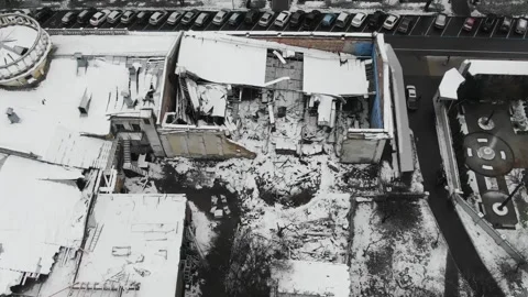 The destroyed building of the theater by a rocket during the Russian invasion of Stock Footage 222948548