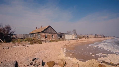 Destroyed buildings on the seashore, The waves roll along the coast, the weather Stock Footage 102386297