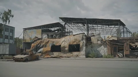 Destroyed cafe building and a burned-out nearby car after rocket fire Stock Footage 201245245