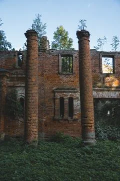 Destroyed columns. A ruined red brick stable. The Kostrovitsky manor house Stock Photos
