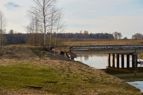 The destroyed concrete bridge over the river. Landscape, horizontal format Stock Photos