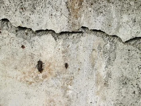 Destroyed concrete wall. The texture of the building with a crack. Pothole and Ilustración de archivo