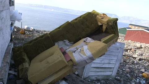 Destroyed couch in the middle of garbage, Ittoqqortoormiit, Greenland Vidéo 104189755