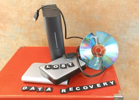 Destroyed DVD disc and lost data on hard drives Stock Photos