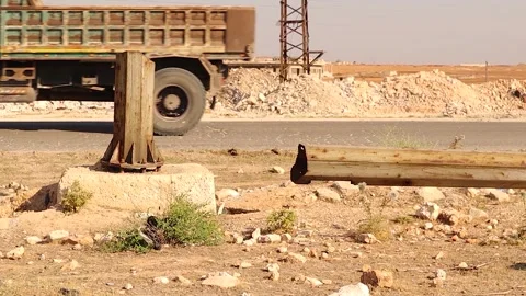 Destroyed electricity pole and debris in deserted area near Aleppo Syria Stock Footage 320109360