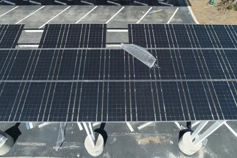 Destroyed by hurricane wind solar panels installed over parking lot canopy sh Stock Photos