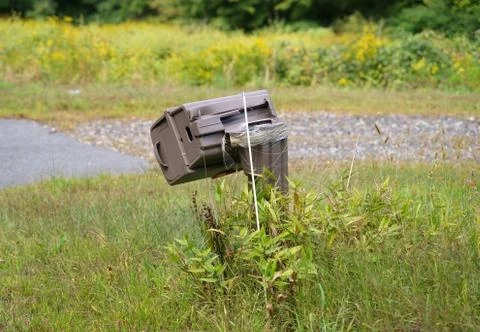A destroyed mailbox either from lack of protective devices during winter snow Stock Photos
