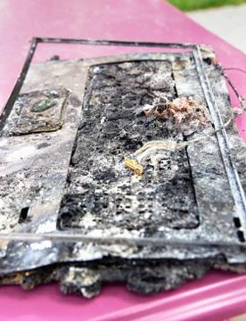Destroyed notebook, melted plastic. Computer damage Stock Photos