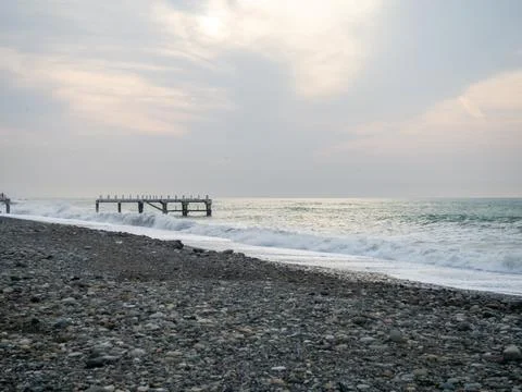 Destroyed pier under the waves. Bad weather at sea. Beautiful seashore with.. Stock Photos