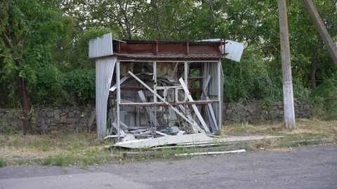 Destroyed public transport stop after shelling. Fragments of public transport Stock Footage 272788194
