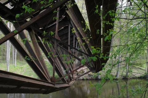 The destroyed railway bridge over the river Stock Photos