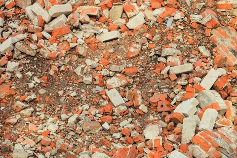 Destroyed red brick building wall. Broken brick. Stock Photos