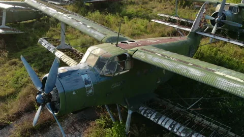 Destroyed rusty green Antonov-2 airplane on grass airfield Video stock 160712659