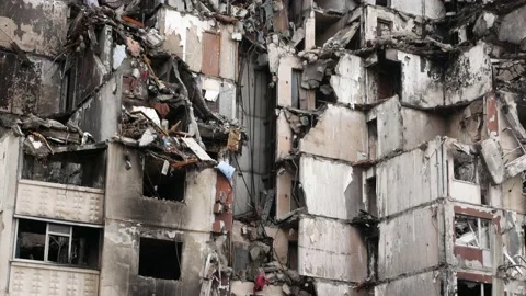 Destroyed by a strike of Russian missiles multi-storey residential building in a Stock Footage 234103807