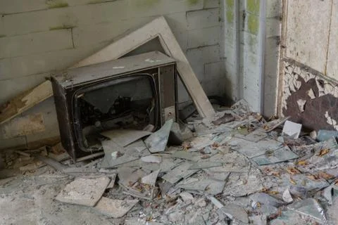 Destroyed television in abandoned house room in the woods Stock Photos