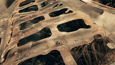 Destroyed vehicle after a fire melted is on the street. Video stock 118359151
