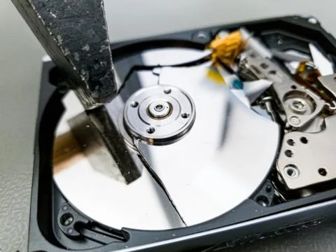 Destroying computer hard drive with a hammer. Stock Photos