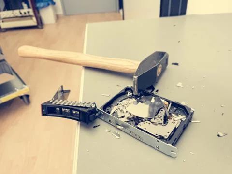 Destroying computer hard drive with a hammer. Stock Photos
