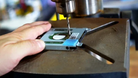 Destroying a hard drive with a drill press slow motion Stock Footage 98771639