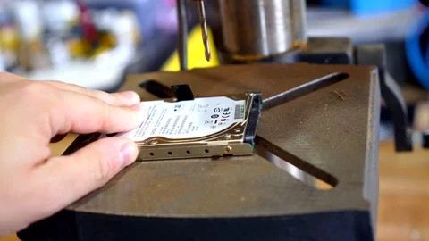 Destroying a hard drive with a drill press Stock Footage 98771676