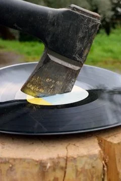 Destroying vinyl record with axe Stock Photos