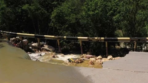 Destructed town road during the flood. Submerged and cracked asphalt landslid Stock Footage 165282733