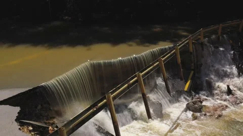 Destructed town road during the flood. Submerged and cracked asphalt landslid Stock Footage 165282758