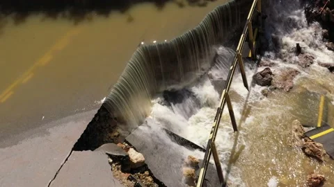 Destructed town road during the flood. Submerged and cracked asphalt landslid Stock Footage 165282769