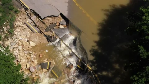 Destructed town road during the flood. Submerged and cracked asphalt landslid Stock Footage 165282788