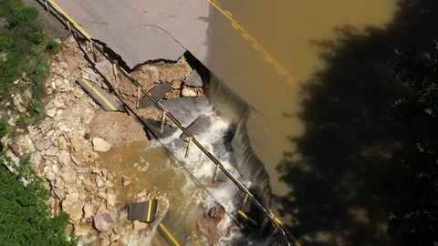Destructed town road during the flood. Submerged and cracked asphalt landslid Stock Footage 165282803