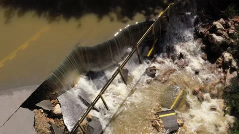 Destructed town road during the flood. Submerged and cracked asphalt landslid Stock Footage 165282838