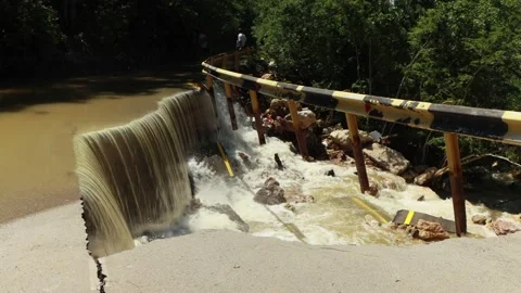 Destructed town road during the flood. Submerged and cracked asphalt landslid Stock Footage 165592017