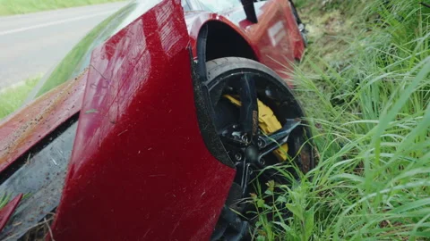 Destructed wheel and bumper of red sport car after dangerous road accident 動画素材 345439780